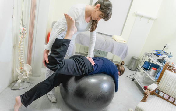 Patient Doing Pilates with Physical Therapists, Rehabilitation After Back Problem