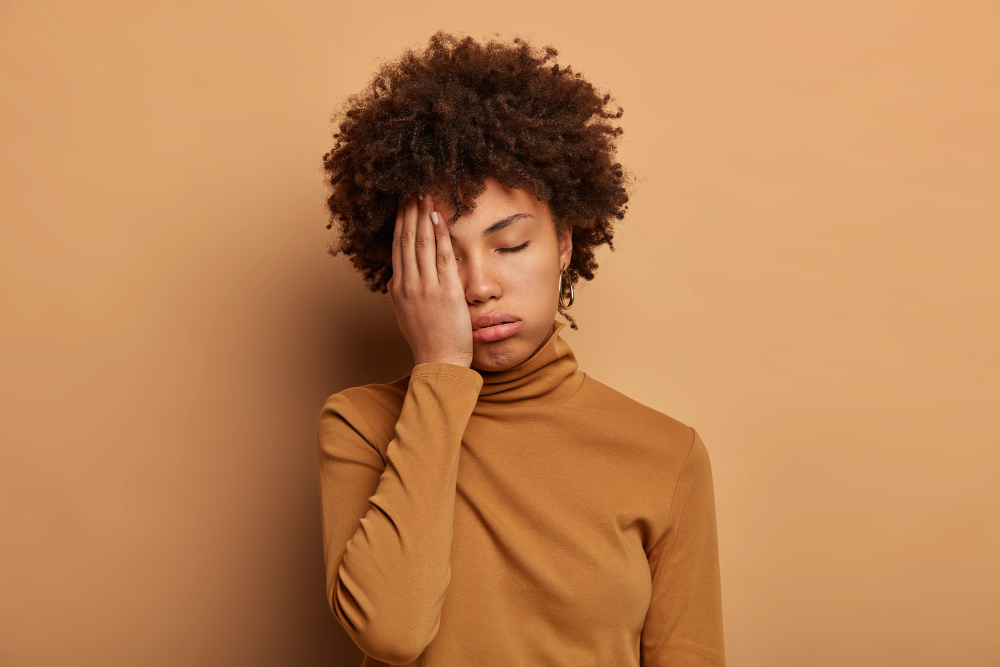 Photo of tired curly woman